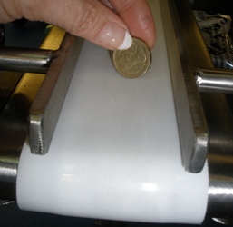 Small Conveyors showing a pound coin